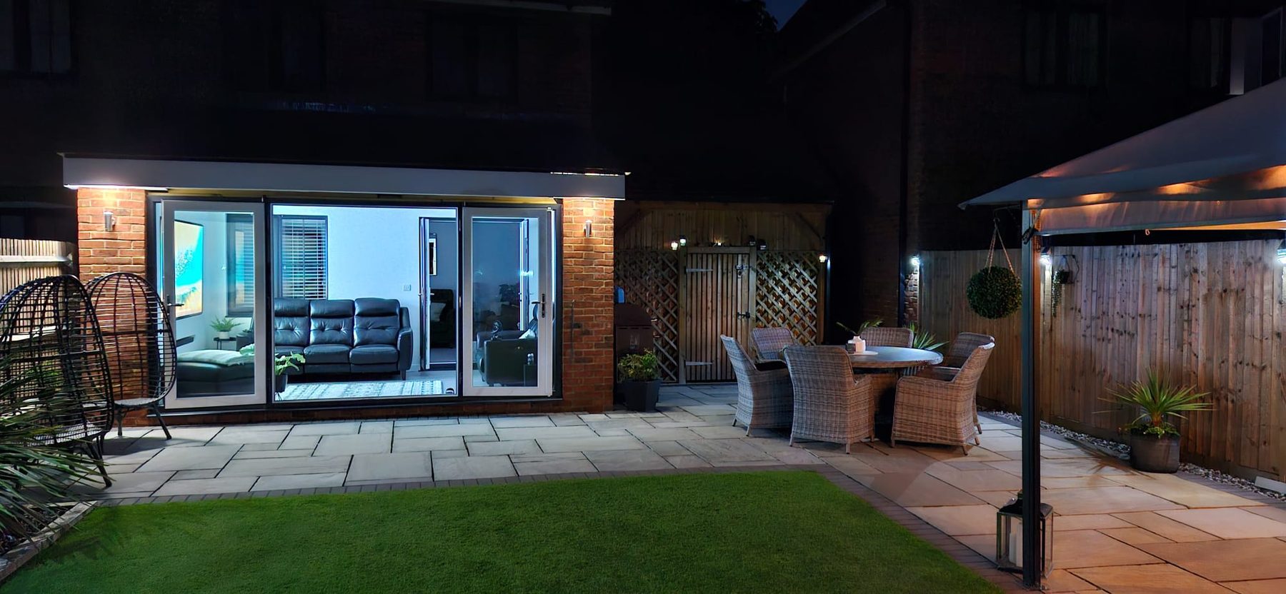 Finished single storey extension lit from inside at dusk