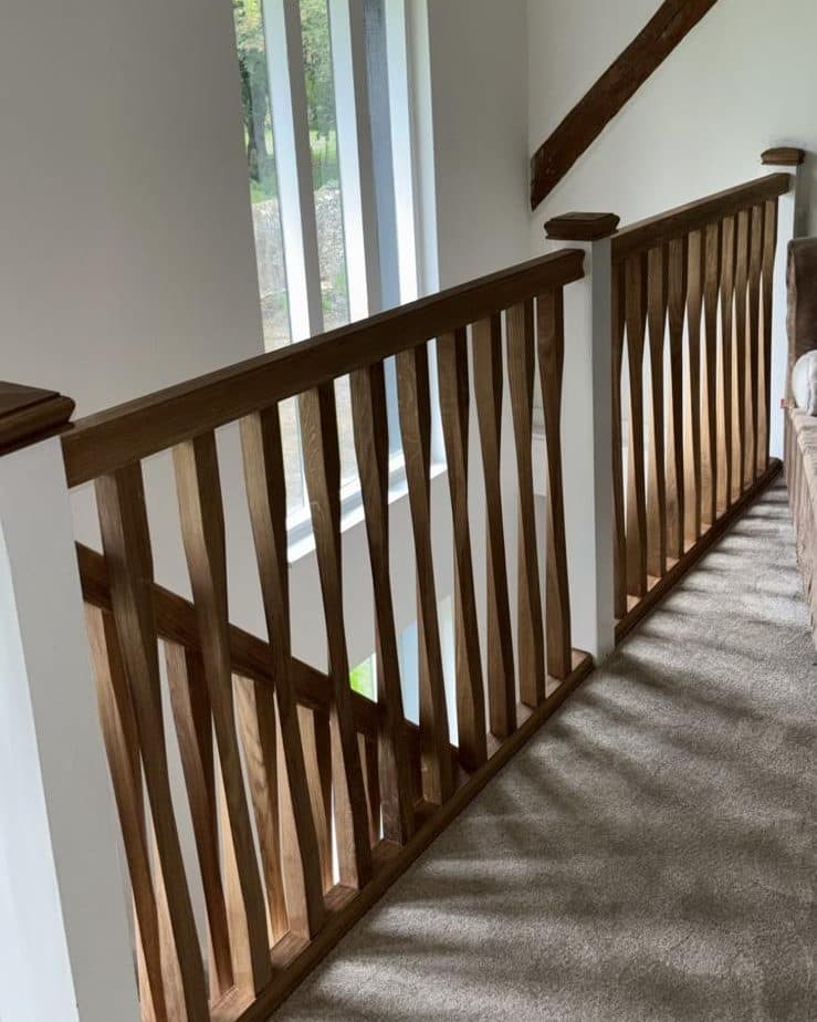 The landing after, with an oak handrail and twisted oak spindles along its length