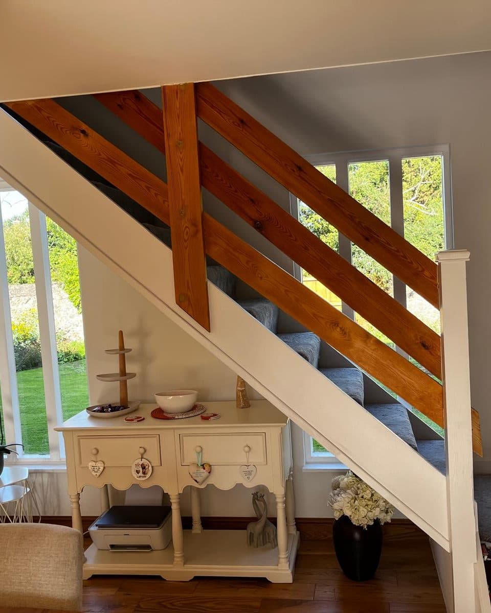 The staircase before, with wide pine boards fixed diagonally as the balustrade